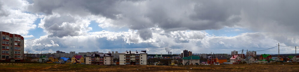 Fototapeta na wymiar Novovoronezh, Russian Federation, 20 April 2017. Panorama of the city, North district, cottages, cooling towers and church, spring