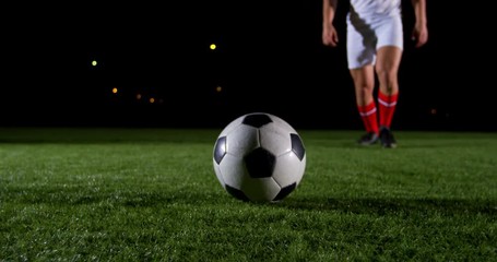 Soccer player kicking the ball 