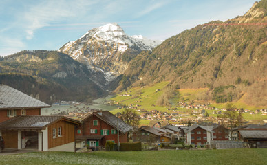 Fototapeta na wymiar Snowy mountains and houses in Switzerland