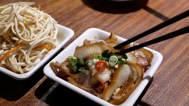 Motion of people eating appetizers on table inside Chinese restaurant with 4k resolution.