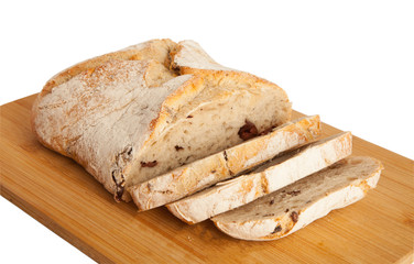 Bread, ciabata with dried tomatoes and olives, on a board, isolated on white background