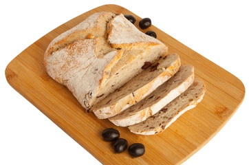 Bread, ciabata with dried tomatoes and olives, on a board, isolated on white background
