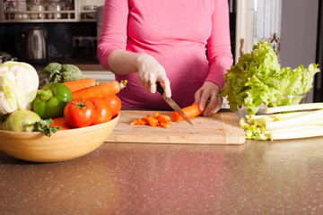 Pregnant woman is cooking