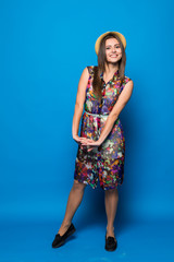 Young girl posing on blue background in studio.
