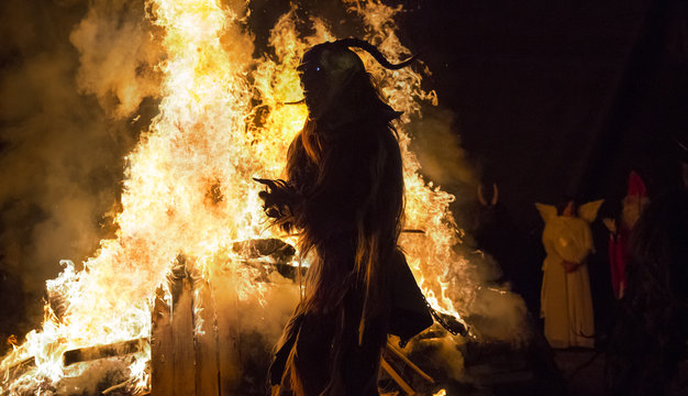 Adult in Krampus costume at fire