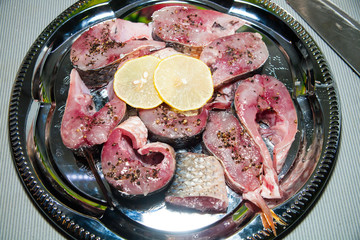salmon fillet with lemon lime dill and spices on marble background. Set for salting fish. top view raw fish dishes pickled fish in Korean style