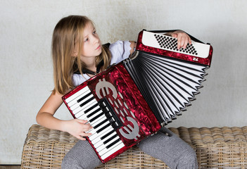 Close up of a girl accordionist focused on playing the accordion