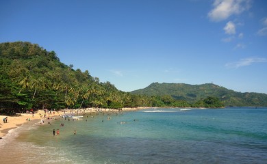 Beautiful beach with green hill on the background