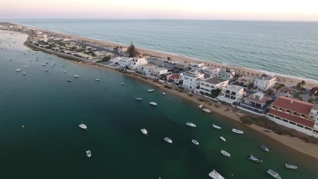 Flying above the Faro beach (Praia de Faro) during sunset, Algarve, Portugal