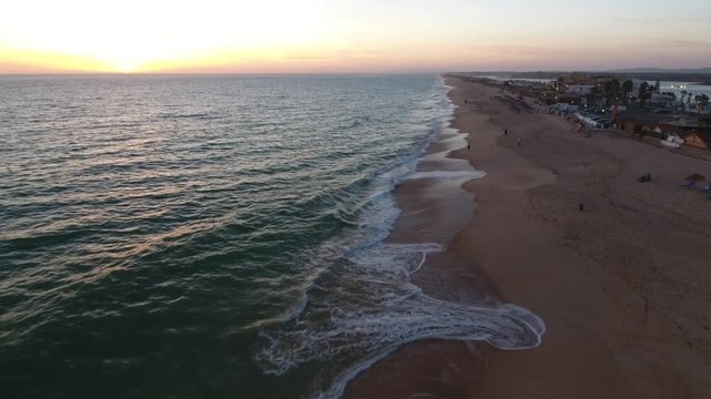 Flying above the Faro beach (Praia de Faro) during sunrise, Algarve, Portugal