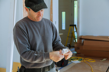 A carpenter works on woodworking Man collects furniture boxes.