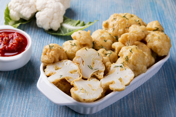 fried cauliflower in batter on a wooden surface