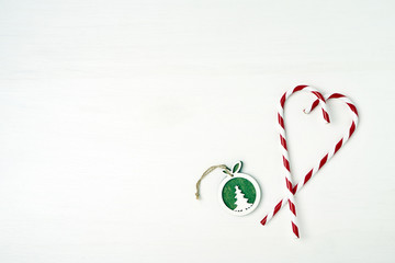 Christmas greeting card. Christmas decoration on white wooden background. Copy space, top view.