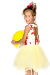 Little girl is playing with a ball