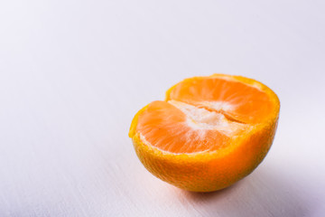 Half of a small mandarin isolated on white background