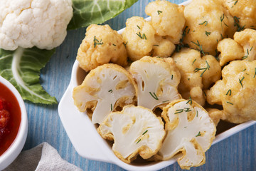 fried cauliflower in batter on a wooden surface
