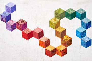 Abstract design of colorful pieces fabrics that look like cubes