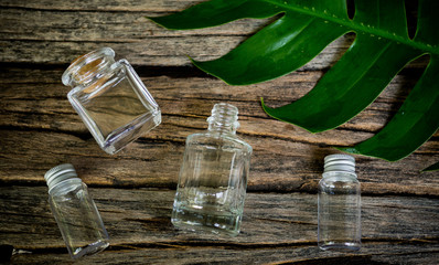 natural cosmetics bottle containers with green leaf on white background. empty bottle ,natural beauty skincare product,  beauty product concept 