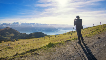 Male photographer are shooting view of Rigi mountain in switzerland