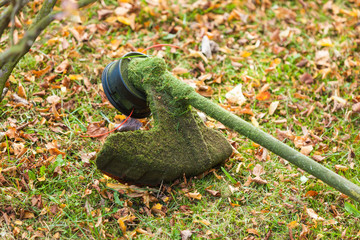 Mower brushcutter on green grass