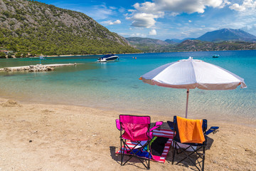 Fototapeta na wymiar Umbrella and sundecks on beach, Greece