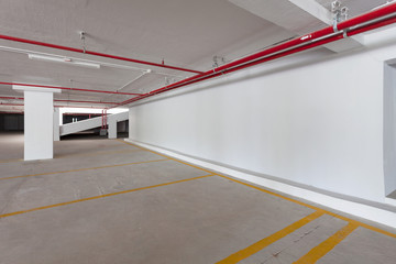 Empty parking garage underground interior in apartment or business building office.