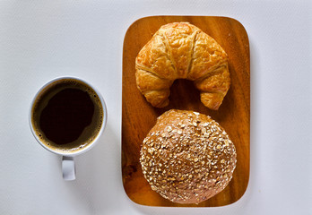 Coffee cup and croissant breakfast in the morning 