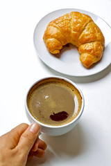 Coffee cup and croissant breakfast in the morning 
