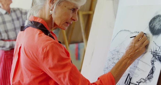 Portrait of artist drawing sketch on canvas 