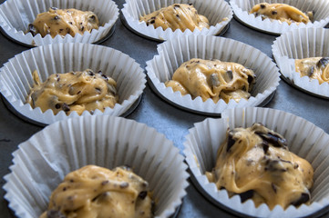 Raw cupcake dough in tray ready to go in the oven. 
