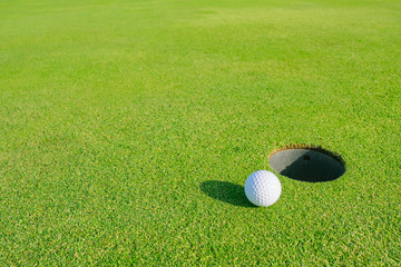 Golf Course with Golf Ball on putting green. Golf is a sport to play on the turf
