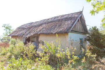 Ruined old house. Ruins of house made of shell rock, straw and clay in the village. Poor old village. old ruined country house.