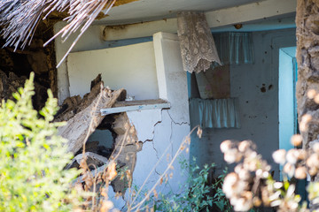 Part of Ruined old house. Ruins of a house made of shell rock, straw and clay in the village. Poor old village.