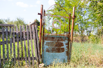old rickety gates. Old rusty gate in an abandoned house. Broken gate.