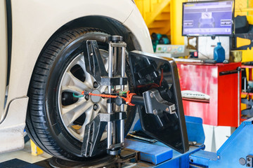 Closed up of an auto wheel : wheel alignment. Balancing tire wheel machine. Tyre assembling. Tire...