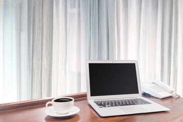 Fototapeta premium Laptops with white coffee mug on wooden desk