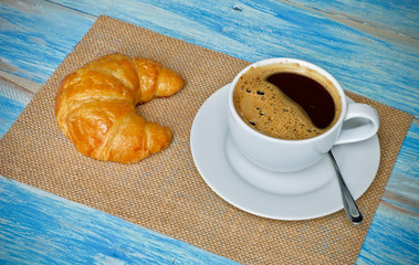 Coffee cup and croissant breakfast 