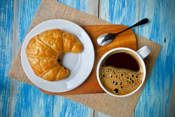 Coffee cup and croissant breakfast 