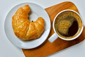 Coffee cup and croissant breakfast 