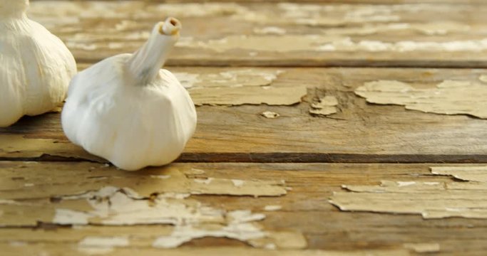 Garlics on wooden plank 