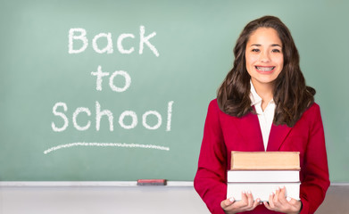 Back to School. Pretty ethnic or Hispanic teen in Front of Chalkboard