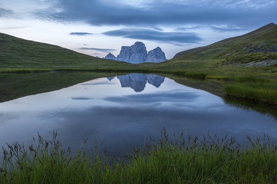 Pelmo mount reflected on Baste lake at twilight, Mondeval, Dolomites, Italy