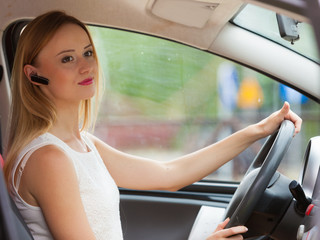 woman driving car with headset