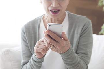 An old lady master with smartphones