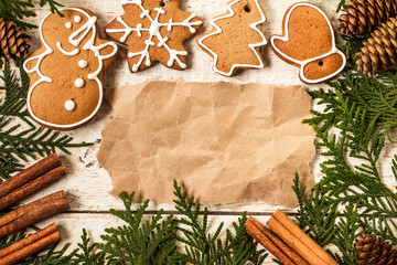 Christmas decoration with paper sheet on wooden table.