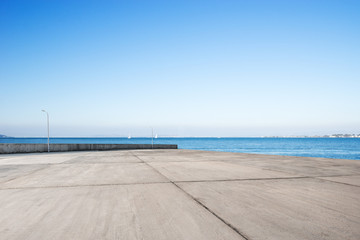 empty concrete floor with blue sea in blue sky