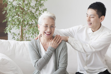 An old lady got her grandson to massage her shoulder