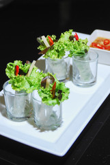 green salad row on white plate