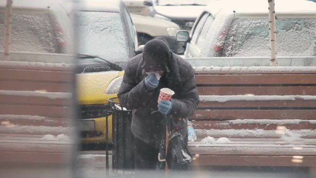 a homeless woman begging on the street