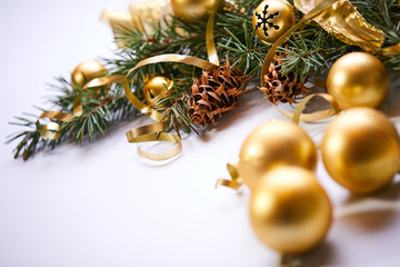 Christmas tree branch with gold balls and ribbons